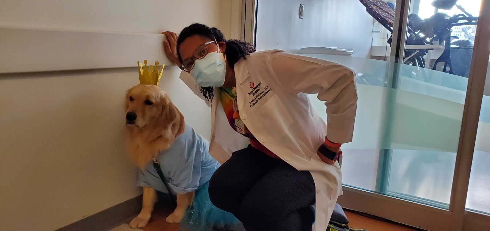 Pediatric Rehabilitation Fellow Jensine’ J. Norman, MD, posing with a therapy dog.